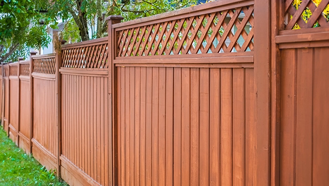 A newly installed wooden fence in a yard.